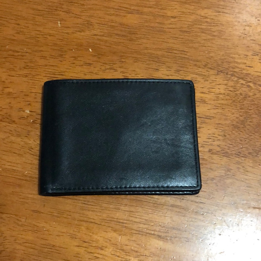 NWOT- never used Men’s bifold genuine leather wallet.